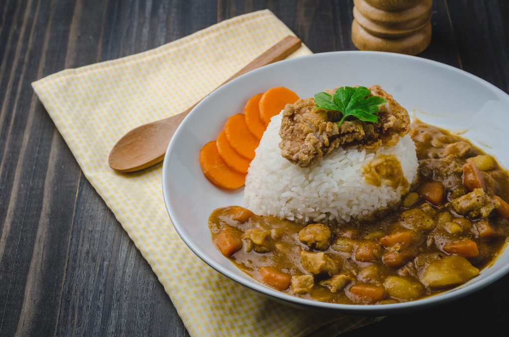 Tonkatsu, Japanese Curry Rice with deep-fried pork cutlet on wooden table